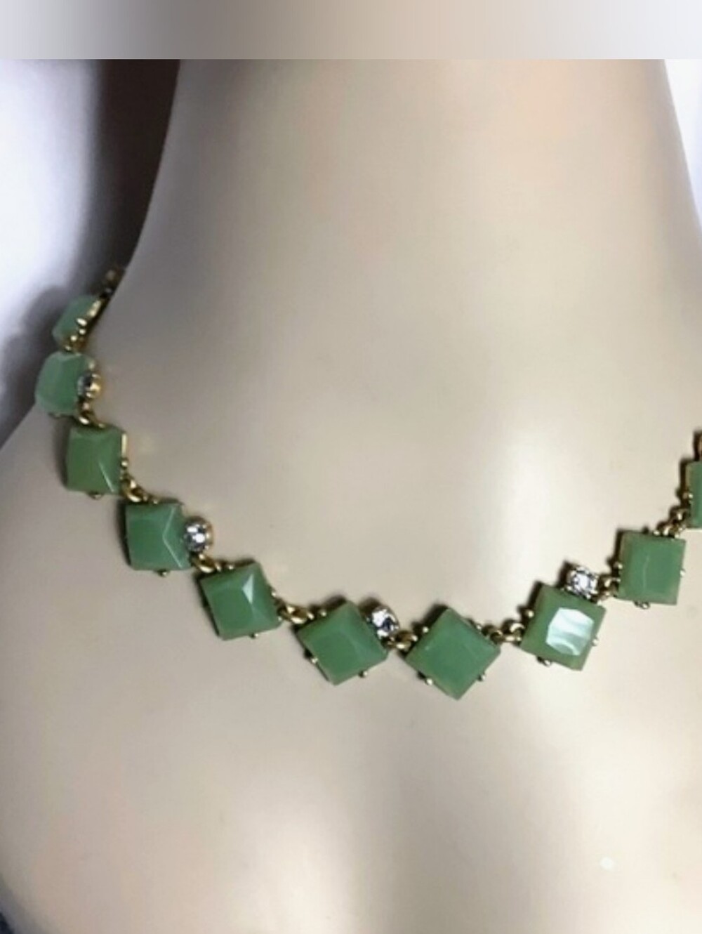 Faceted green stones with rhinestone accents and gold tone hardware necklace